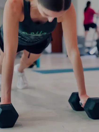 My client showing great form during a dumbbell plank row, an exercise that builds core stability and back strength simultaneously.