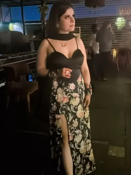 Black makes everything more elegant. I am wearing a custom black floral dress with a thigh-high slit, a perfect outfit for a classy evening or a cards party.