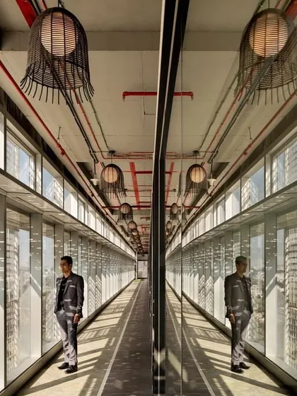 A creative shot of the glass-walled corridor at CorporatEdge, using reflection to create an illusion of infinite space. This highlights the dynamic and visually engaging nature of our circulation area designs.