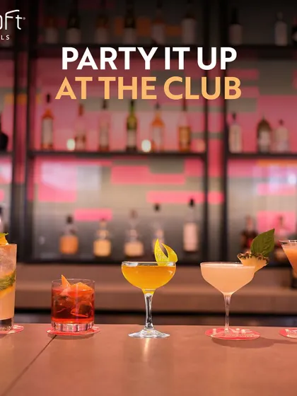 A lineup of colourful cocktails on the bar at Aloft Hotels. This image invites you to party it up at the club with a diverse selection of expertly mixed drinks.
