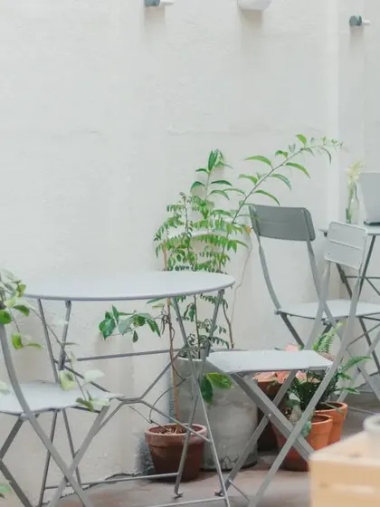 Our simple and elegant outdoor seating, surrounded by greenery. It is the perfect spot to work on your laptop or just enjoy the quiet.