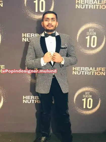 A client looking sharp in a black and white patterned tuxedo jacket. This is a great choice for a formal event where you want to stand out from the crowd.
