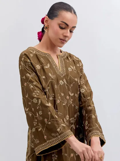 A close-up of an olive green kurta with intricate all-over floral embroidery. This is a testament to the language of grace spoken through threadwork, a hallmark of the pieces I curate.