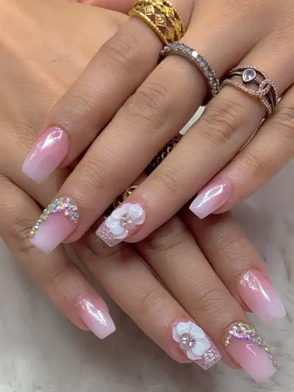 A shorter, stylish set with a pink and white ombre, 3D flowers, and rhinestone accents.