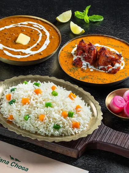 A rich meal combo featuring Dal Makhani, Butter Chicken, and vegetable rice.