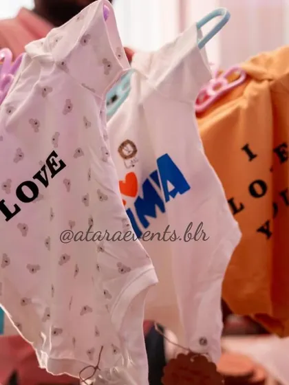 Custom-printed baby onesies, a fun activity at a "Coco Baby" shower. Guests could personalize these for the baby, creating a heartfelt and memorable gift.