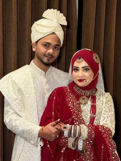 A close-up of my beautiful Hijabi bride. The details of her makeup, from the perfectly blended eyeshadow to the crisp red lip, are clearly visible.