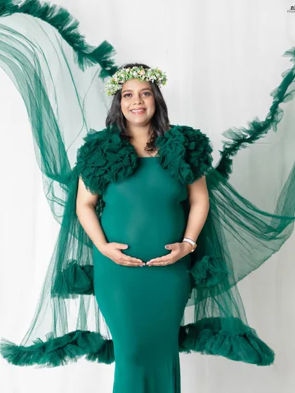 The emerald green gown with its long, flowing tulle cape is a client favorite. It creates a beautiful, ethereal effect that looks incredible in photos, especially when we add a little air from a fan.