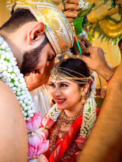 An intimate close-up of the Jeerige Bella ritual, a key moment in many Kannadiga weddings.