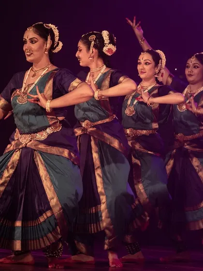 A synchronized movement, showcasing the unity and coordination of the dance troupe.
