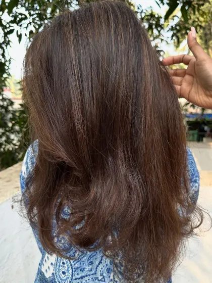 The final result of the 'Warm Caramel' color service.