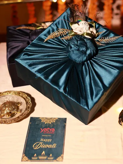 A corporate Diwali gift I created for Yatra. The hampers are wrapped in luxurious teal satin fabric, reflecting a premium and elegant brand image.