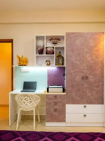 A bedroom study table and wardrobe unit with a unique floral laminate finish. This is a great example of how to move beyond solid colors for a personalized look.