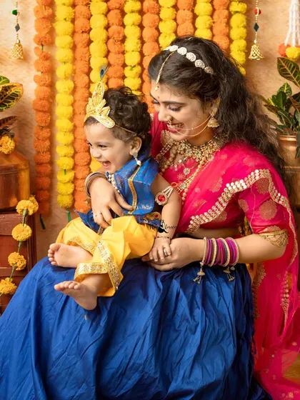 Pure laughter and joy between a mother and her baby during a Janmashtami themed session.
