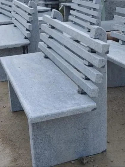 A modern-style garden bench with a slatted backrest, made entirely from natural stone. It is extremely durable and weather-resistant.