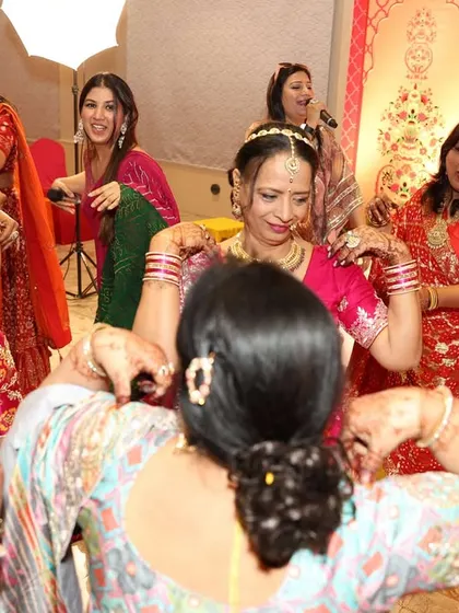 Watching the ladies of the family perform a traditional dance. It's a beautiful display of culture, and I make sure to give it the spotlight it deserves.