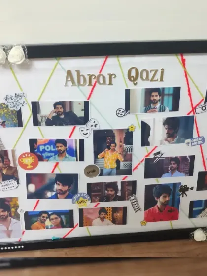 A full shot of the acting-themed photo collage frame, decorated with white paper roses and pearl details.