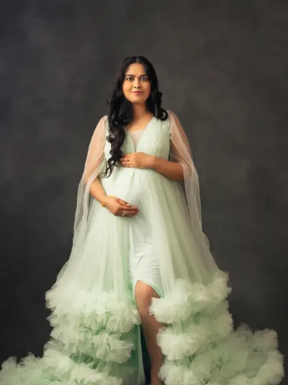 A vision in mint green. This beautiful ruffled tulle gown offers a fresh and elegant look for your special occasion.