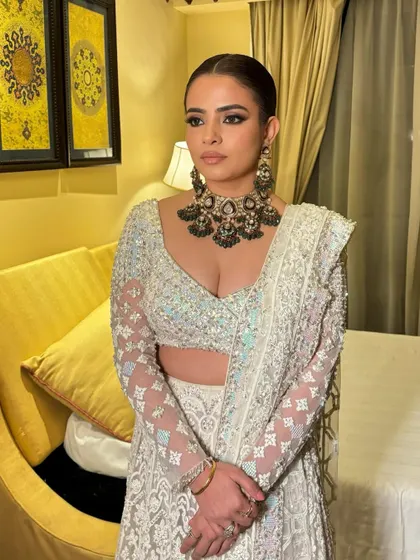 Another angle of this stunning reception look. The heavy kohl is balanced with clean skin and nude lips, letting the eyes and the incredible jewelry make a statement.