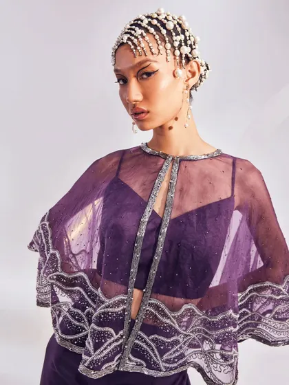 The Zoey Cape Set is your go-to for effortless glam. I designed this lightweight, embellished organza cape to be paired with a bold bustier and fluid trousers.