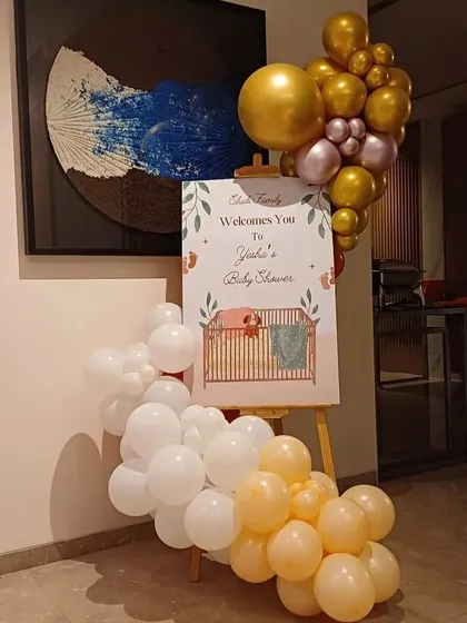 A welcome easel for a baby shower. I provide a custom-printed welcome sign, displayed on a wooden easel and decorated with a matching balloon arrangement.