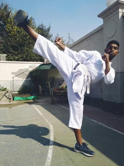 A young student executes a clean side kick with excellent form and focus. Mastering the basics is the first step toward becoming a great martial artist.