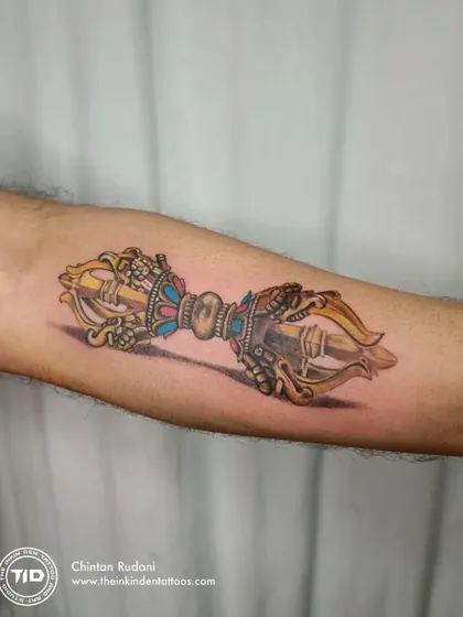 A hyper-realistic color tattoo of a Dorje, a Tibetan Buddhist symbol for indestructibility and irresistible force. The intricate details and 3D effect make this piece a powerful emblem of spiritual strength.