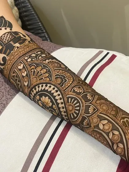 A wider view of the elephant-themed bridal arm, showing how the patterns flow down to the hand.