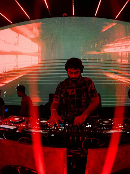 Mixing under the red lights. The atmosphere of the club is a huge inspiration, and I often find myself lost in the process of building a set.
