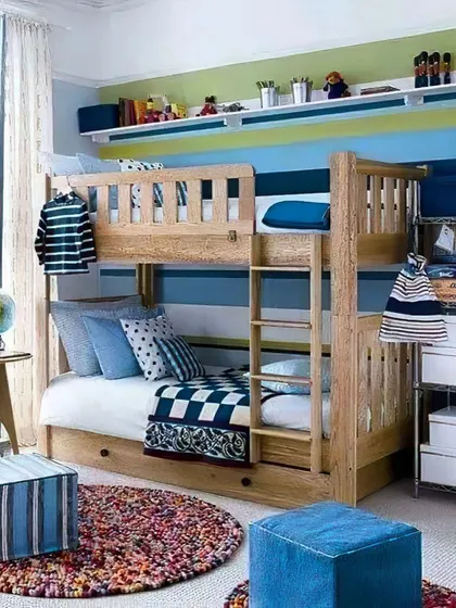 A classic wooden bunk bed in a blue and green themed room. The design includes open shelving for toys and books, creating a cheerful and organized space for kids.