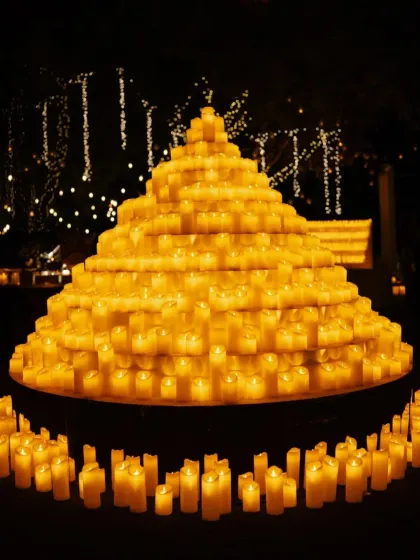 A pyramid of candles creates a powerful and mesmerizing focal point. This installation is a testament to how we use simple elements on a grand scale to create dramatic impact.