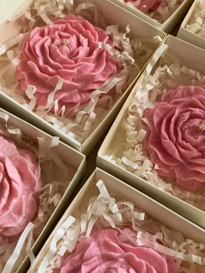 Pink peony candles packed in individual boxes with shredded paper. This is how I prepare them for shipping to ensure they arrive safely.