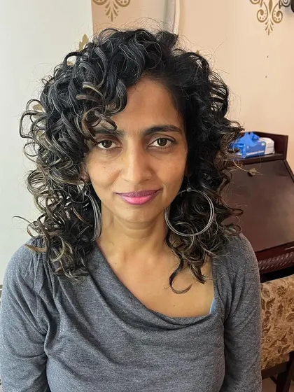 Kritika's new cut enhances her natural curls and gives them a beautiful shape.