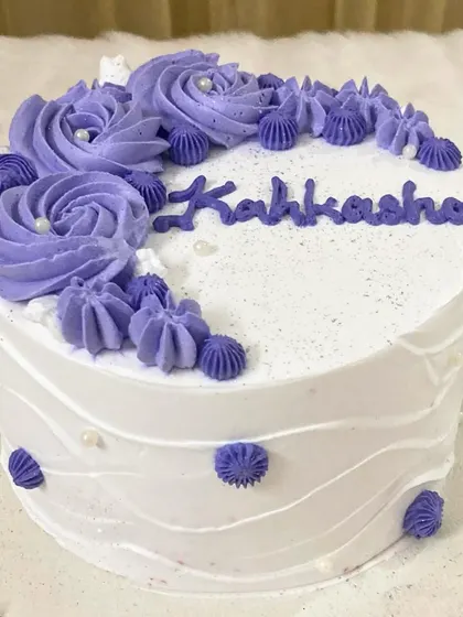 A lovely personalized mini cake in a beautiful lavender shade. The hand-piped rosettes and custom name make it a truly special and intimate celebration cake.