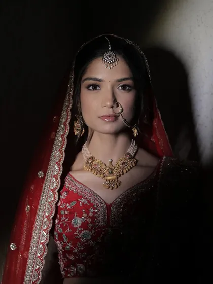 A powerful and regal bridal portrait. The makeup is designed to be striking yet timeless, with a focus on flawless skin and defined features that look stunning in every light.