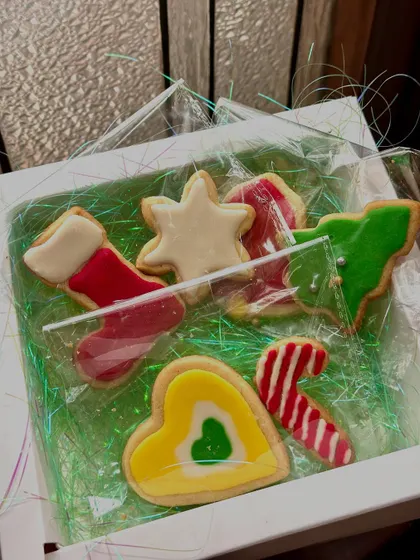 A small, curated box of our iced Christmas cookies. This set includes a stocking, star, heart, candy cane, and tree, perfect as a small token of appreciation or a stocking stuffer.