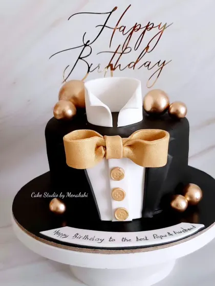 For the perfect gentleman. This tuxedo cake is sharp and stylish, with a crisp white shirt, a black jacket, and a golden bow tie and buttons.