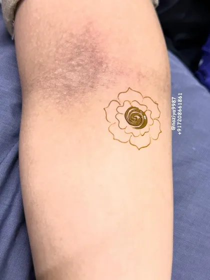 A tiny, simple spiral rose motif. This is a great option for kids or for guests who want the smallest touch of henna.