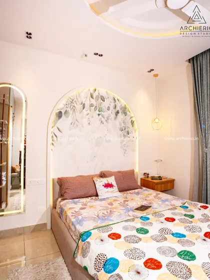 A dreamy bedroom for a young one, featuring a custom wallpaper arch behind the bed. The design includes a cozy bed, a sleek study unit, and a wardrobe with a bay seater for reading.