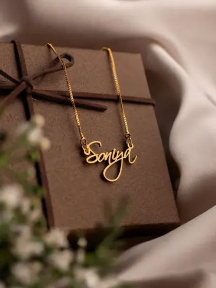 Every necklace arrives ready to make someone's day. This 'Soniya' script necklace is displayed with its elegant gift box, showing that each order is thoughtfully packaged for a perfect gifting experience.