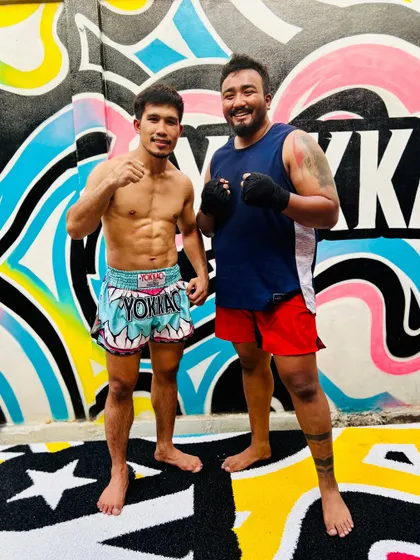 Posing with a trainer at the world-renowned Yokkao Training Center in Thailand. We visit multiple top-tier gyms to get a variety of training experiences.