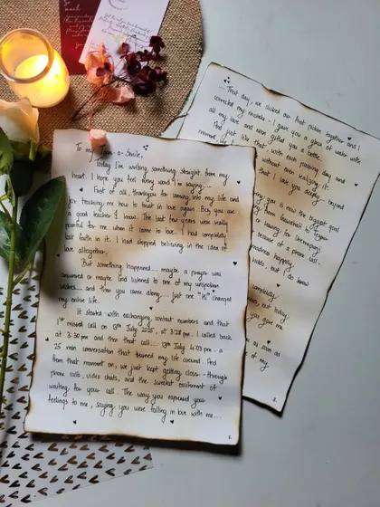 Two pages of a heartfelt letter, ready to be rolled up. The aged paper and handwritten script give it an old-world charm.
