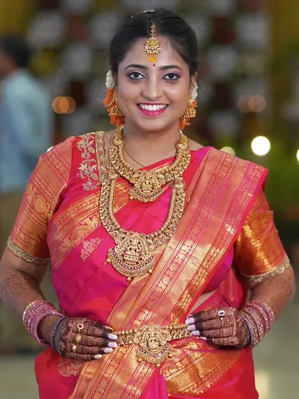 A full view of the reception look. The saree is draped to perfection, with the pleats held neatly by a delicate waist belt, ensuring the look stays immaculate all night.