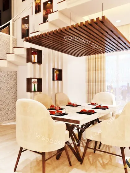The dining area within the same duplex project. A suspended wooden slat ceiling feature elegantly defines the dining space, which is furnished with modern chairs and a marble-top table.