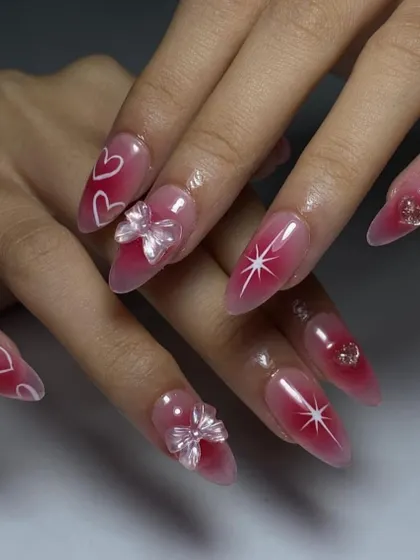 A dreamy, ethereal set with a pink "aura" base, hand-painted hearts and stars, and delicate, iridescent 3D bows.