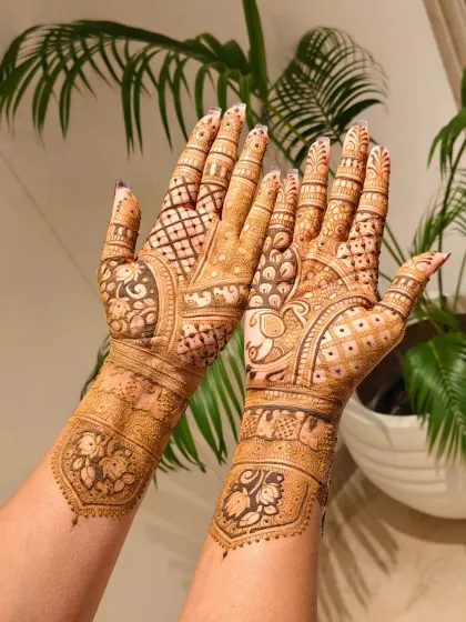 A gorgeous mehndi design featuring traditional elephant and peacock motifs, blended with intricate jaal and floral patterns.