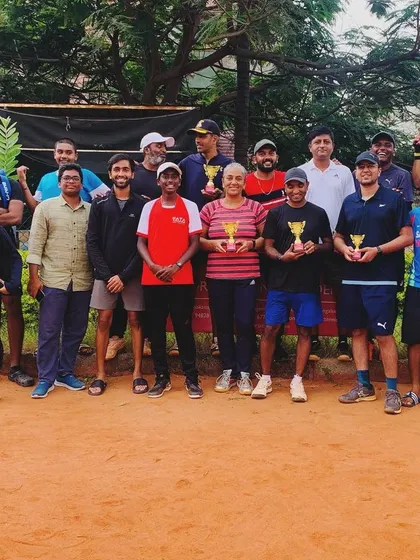 This is our community. A group photo of our players after a tournament day, all sharing the love for the game on our red clay courts.