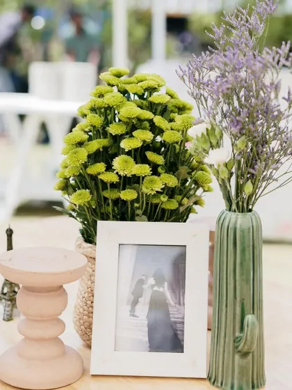 Another combination of a framed photo and unique vases.