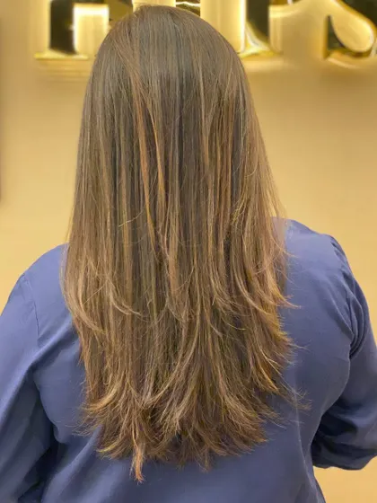 The back of a client's hair, showing the beautiful, long layers and healthy, shiny finish of her new cut.