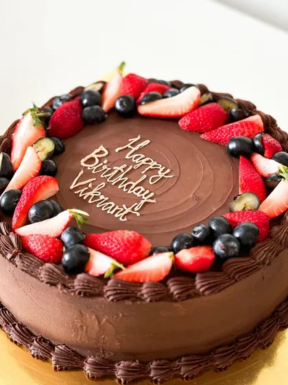 A classic combination of rich chocolate cake topped with fresh strawberries and blueberries. This cake is a testament to the simple joy of chocolate and delicious berries.